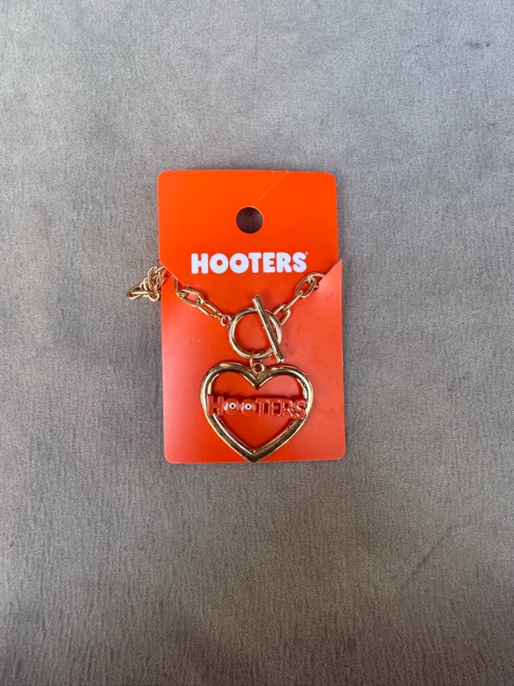 Hooters Gold Heart Logo Bracelet with Orange Tag